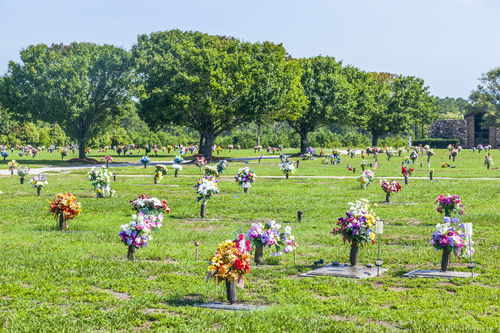 Cemetery with bright green grass and trees